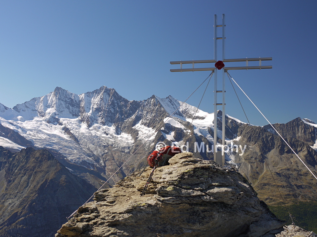 The Almagellerhorn's summit cross and the Mischabel peaks