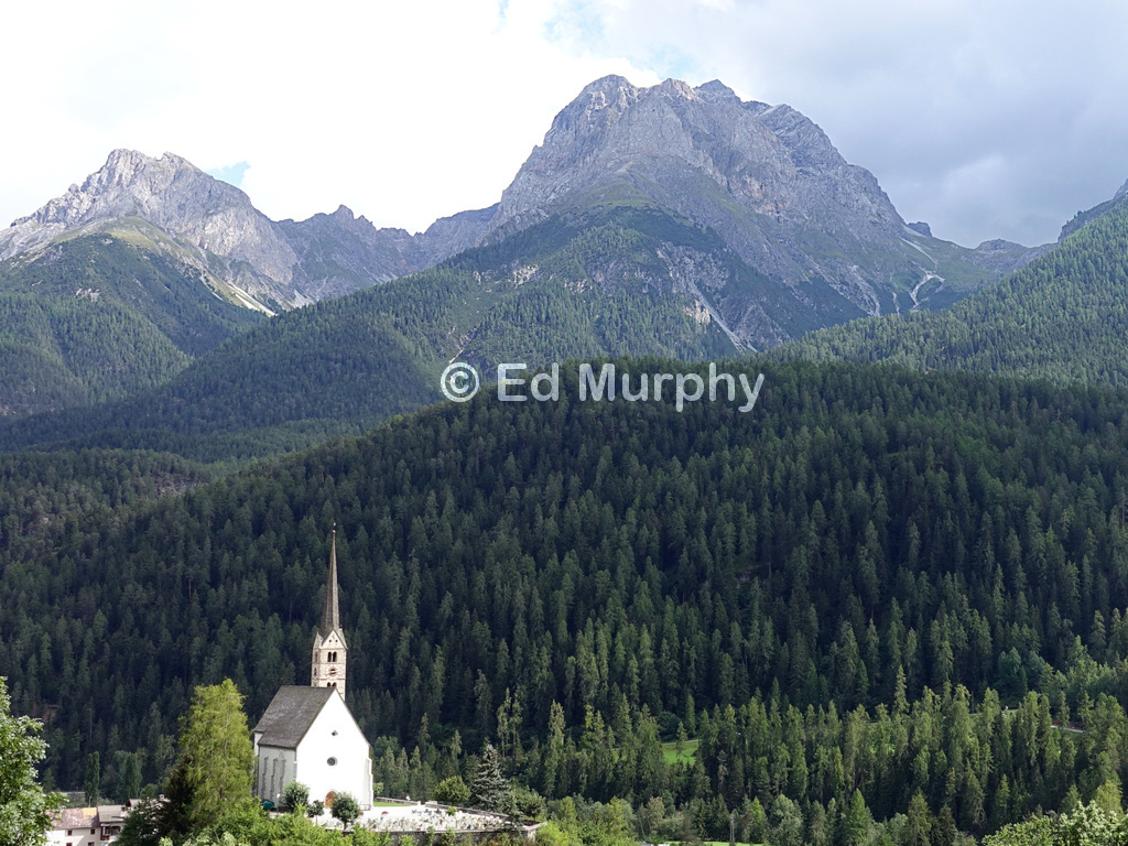 Scuol's protestant church and its Piz Lischana backdrop